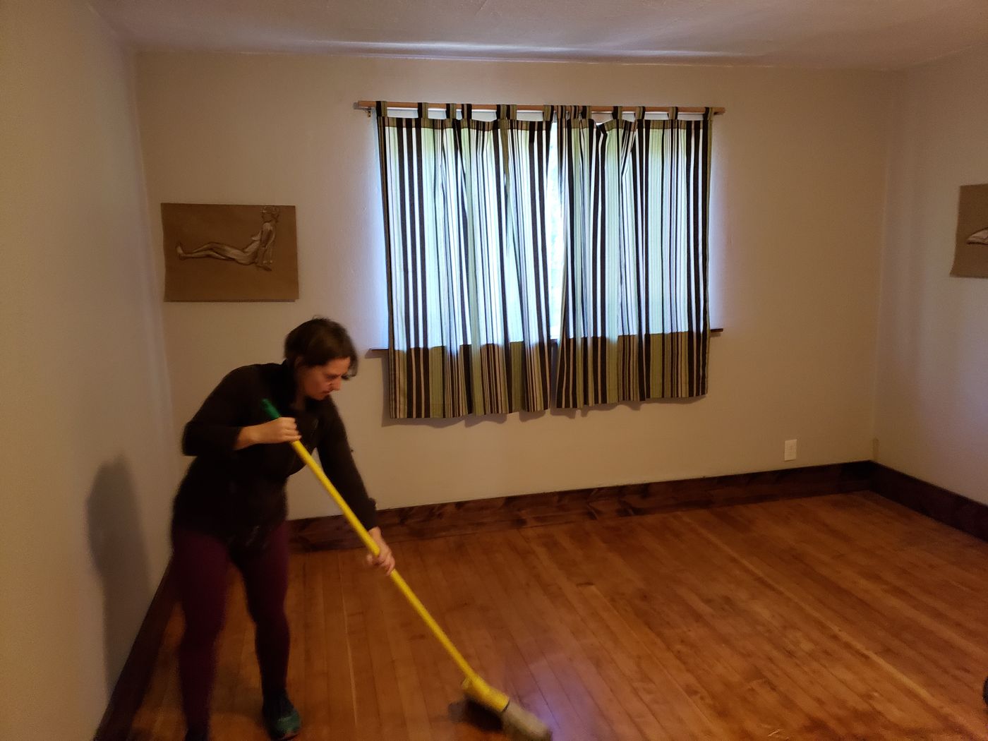 A customer sweeping her empty house as the move-out finishes